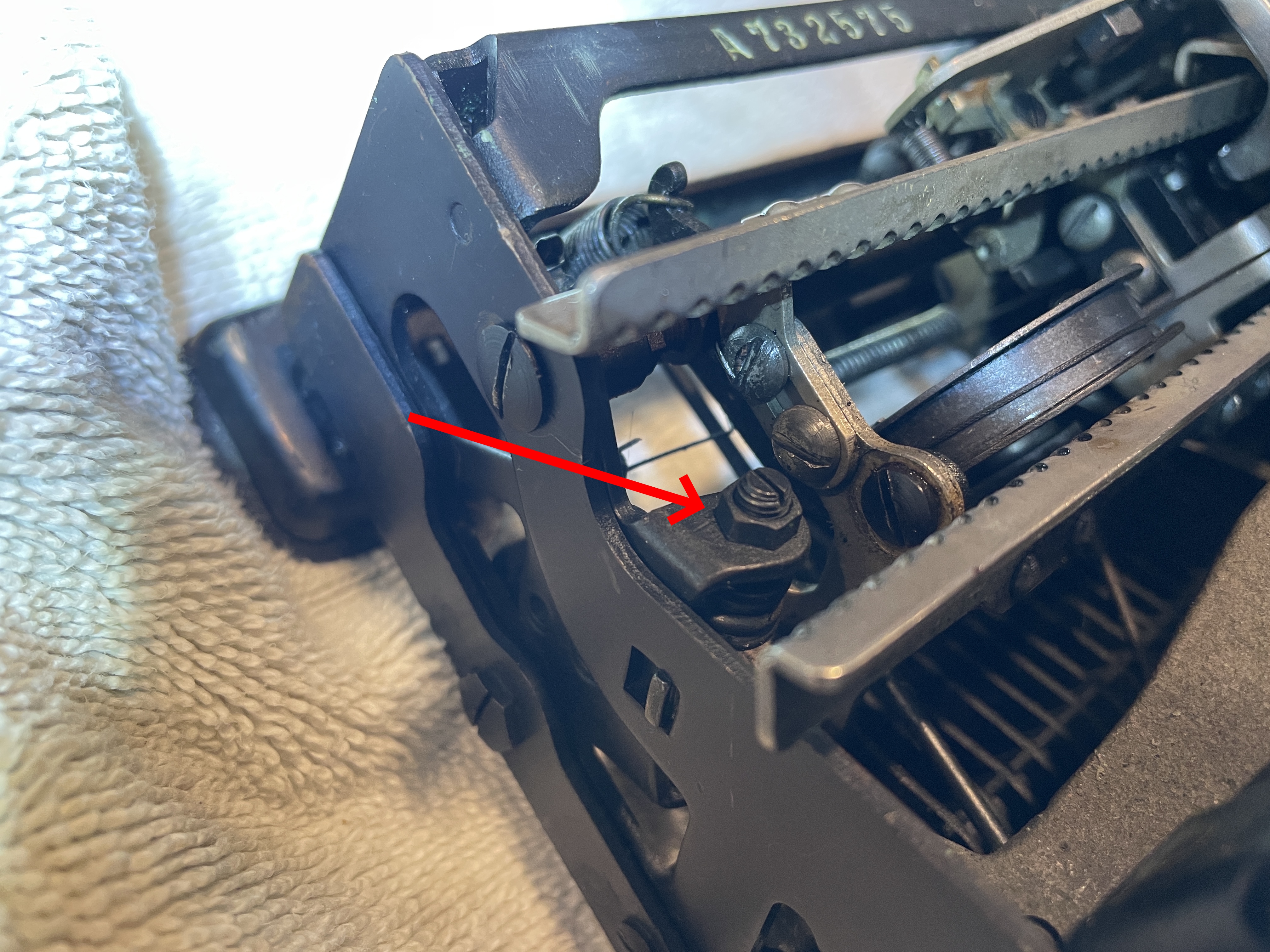 adjustment screws on either side of Royal De Luxe behind ribbon spools allow adjustment of capital letters