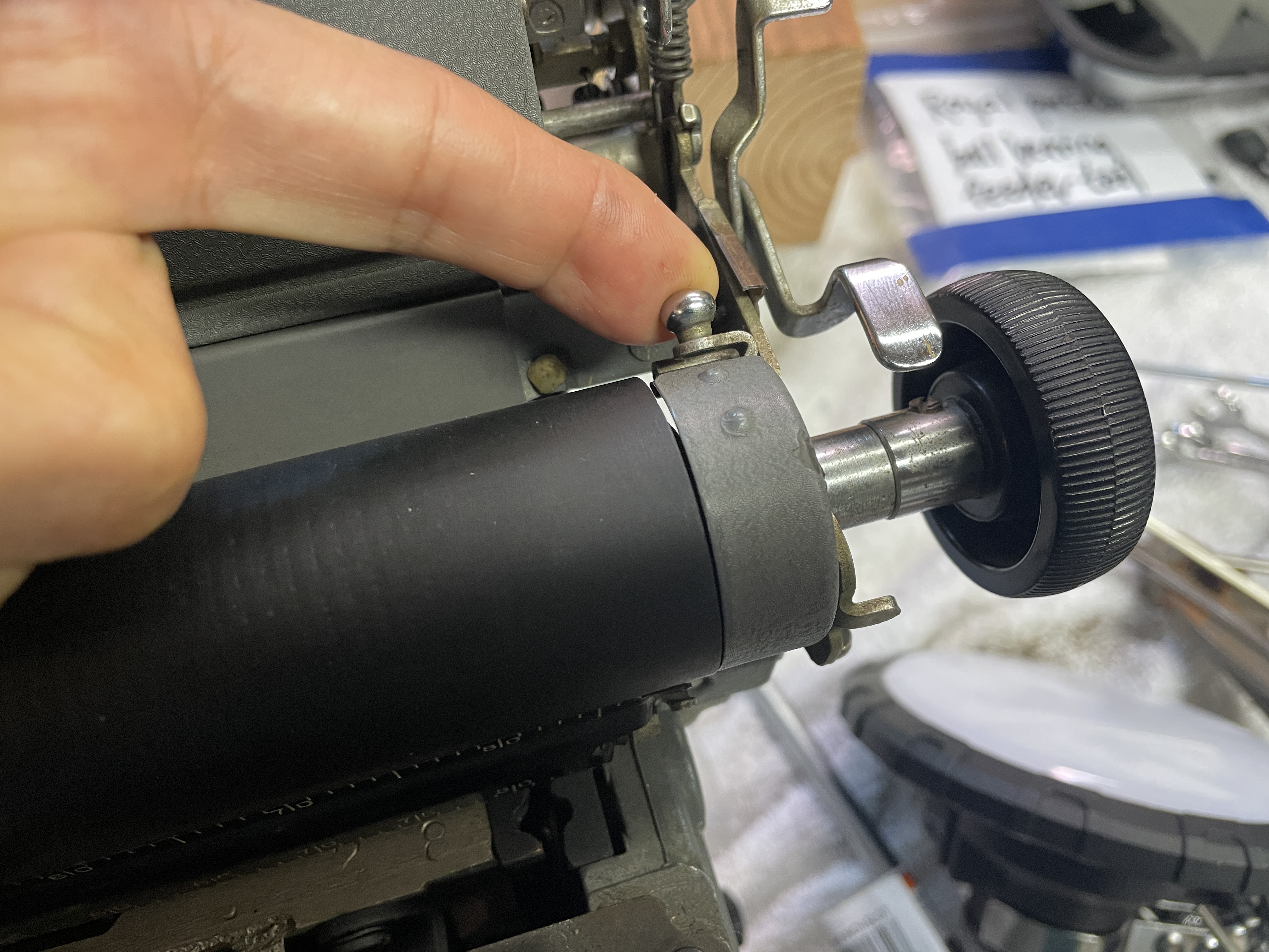 removing the platen from a Royal KMG. First lift cover plate at the right end of the platen.