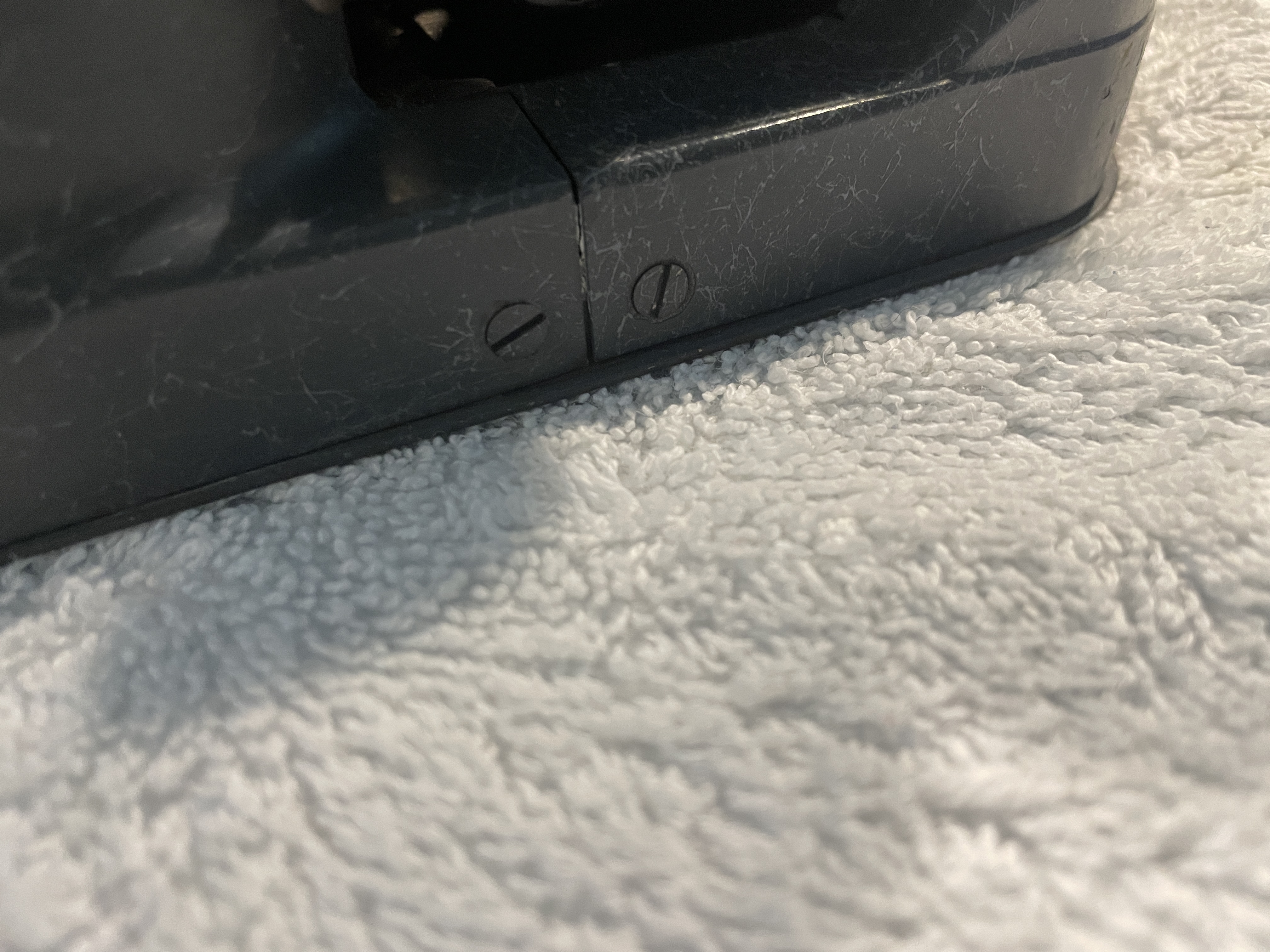 screws holding the front and back cover plates on a 1943 Hermes Baby typewriter