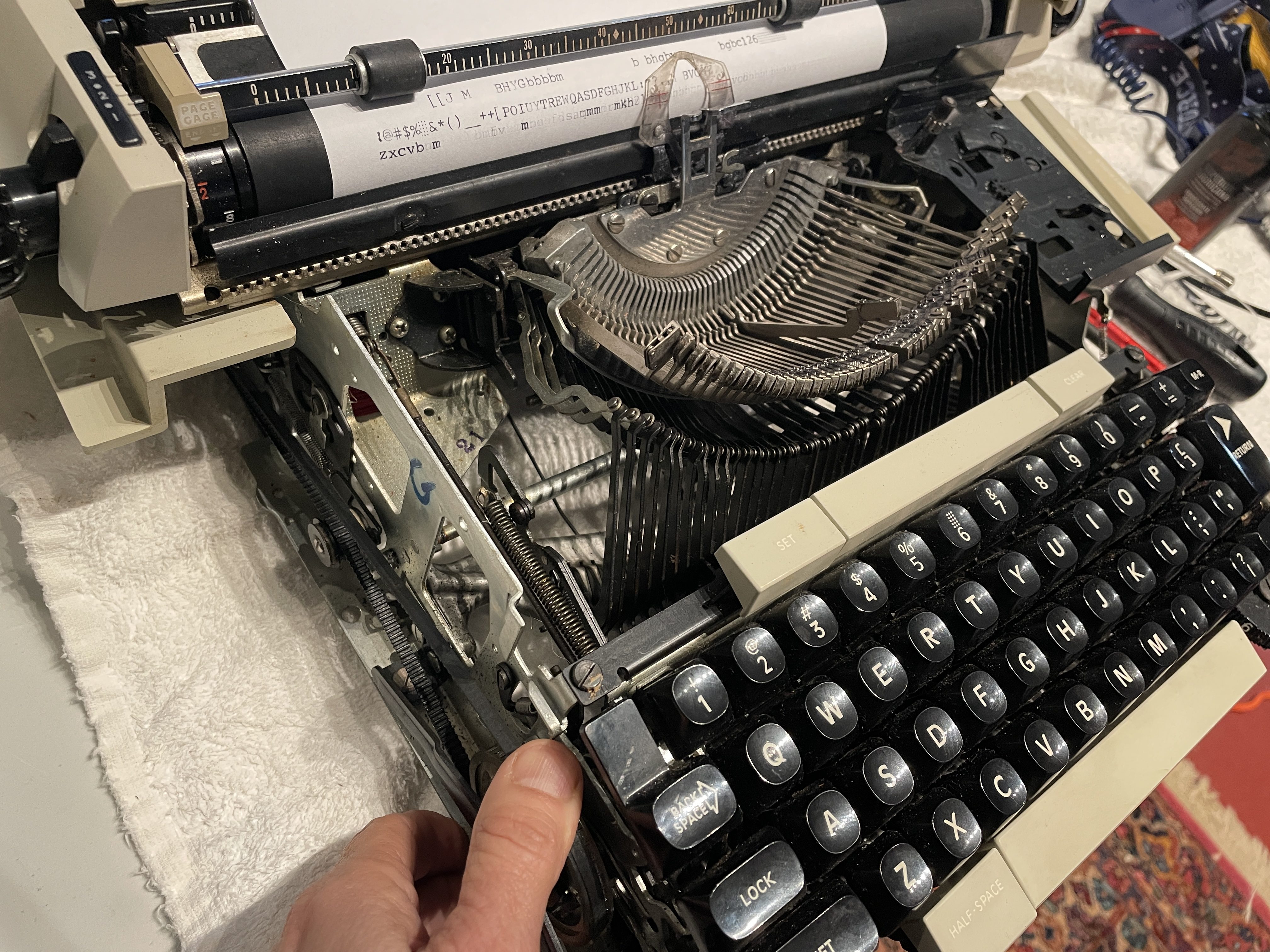 manually working belt pulley to raise a typebar