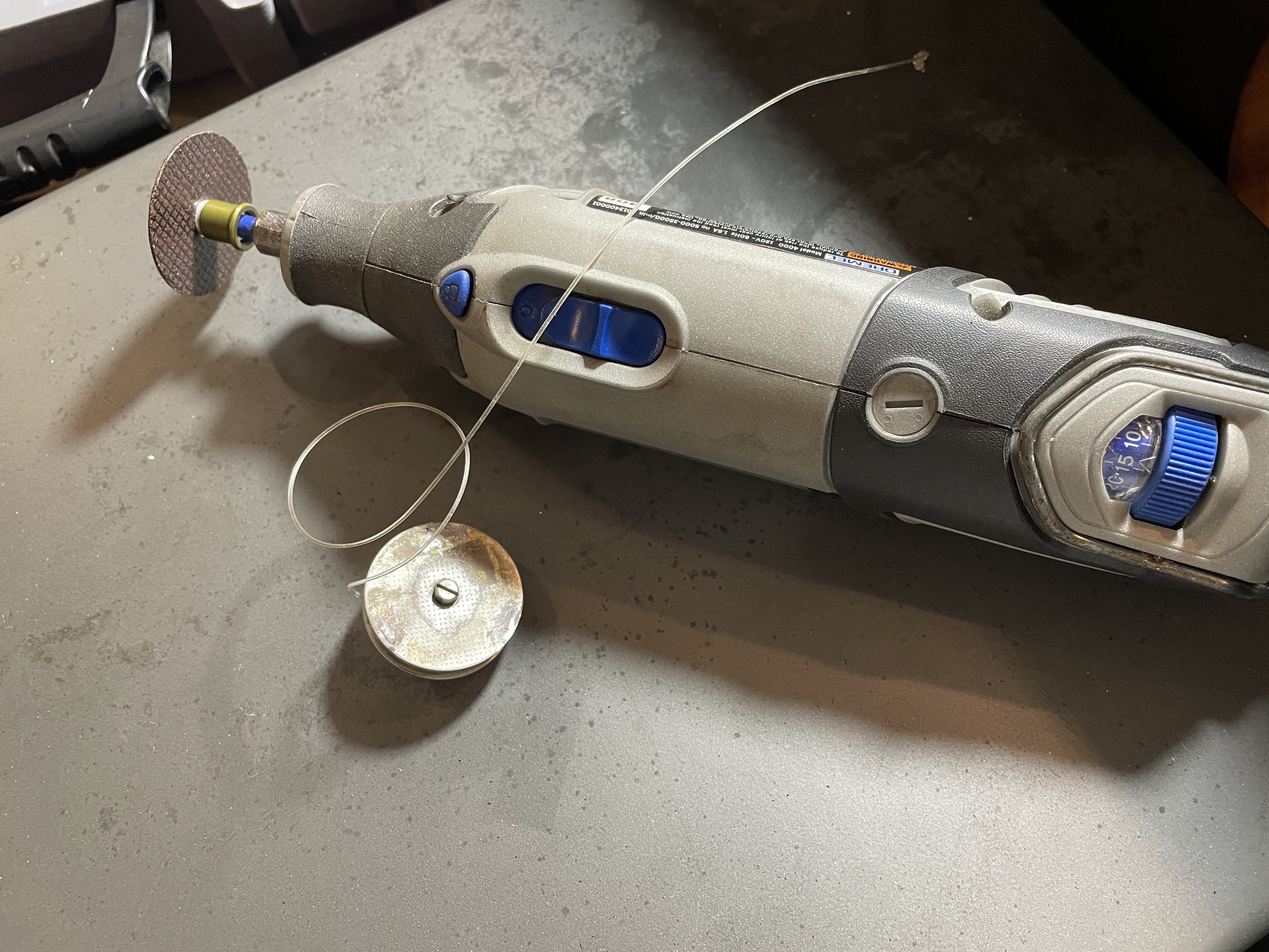 Dremel grinds off tabs on mainspring case of Consul 232 typewriter