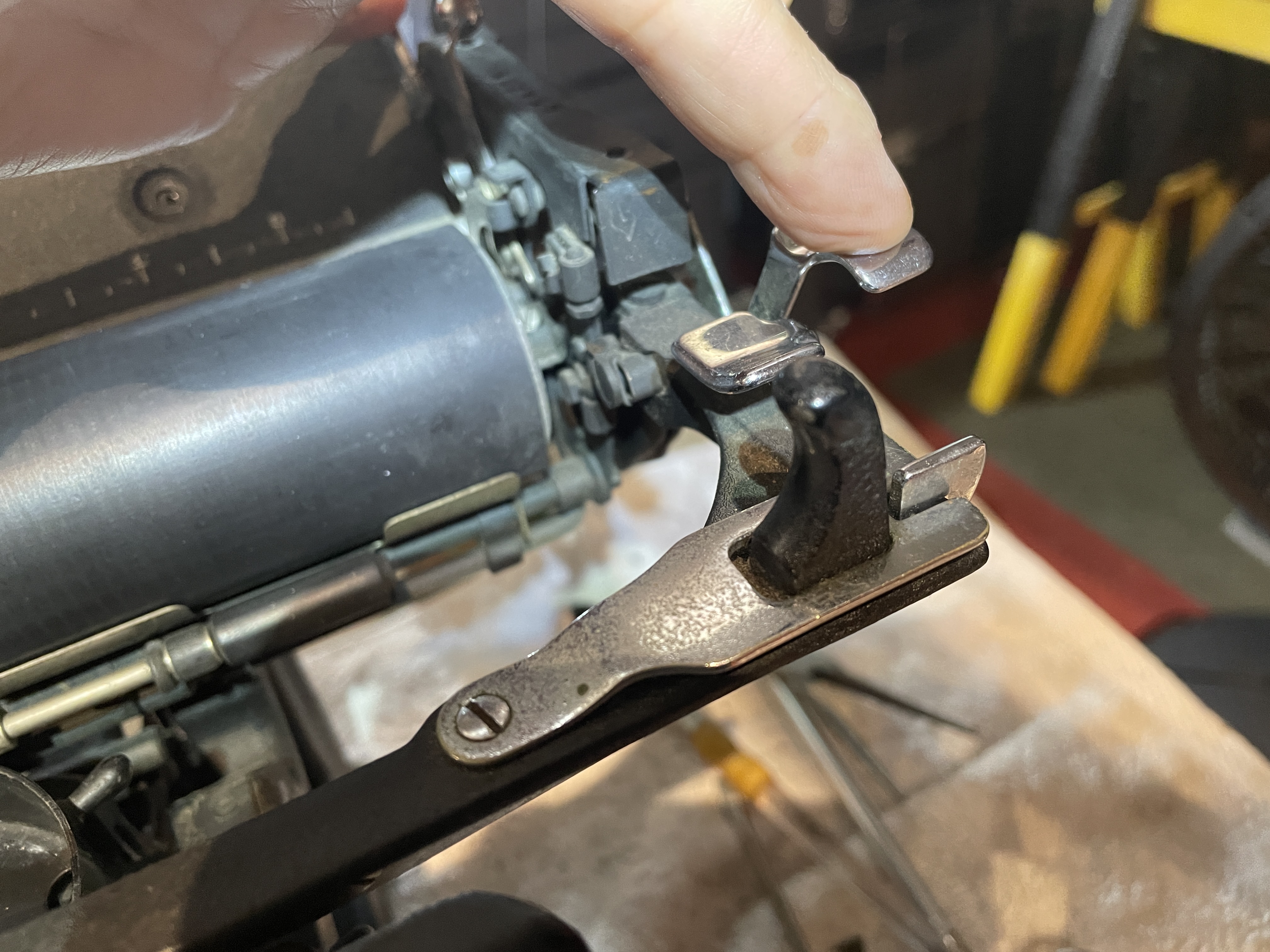 engage paper relase to access screw holding paper rest