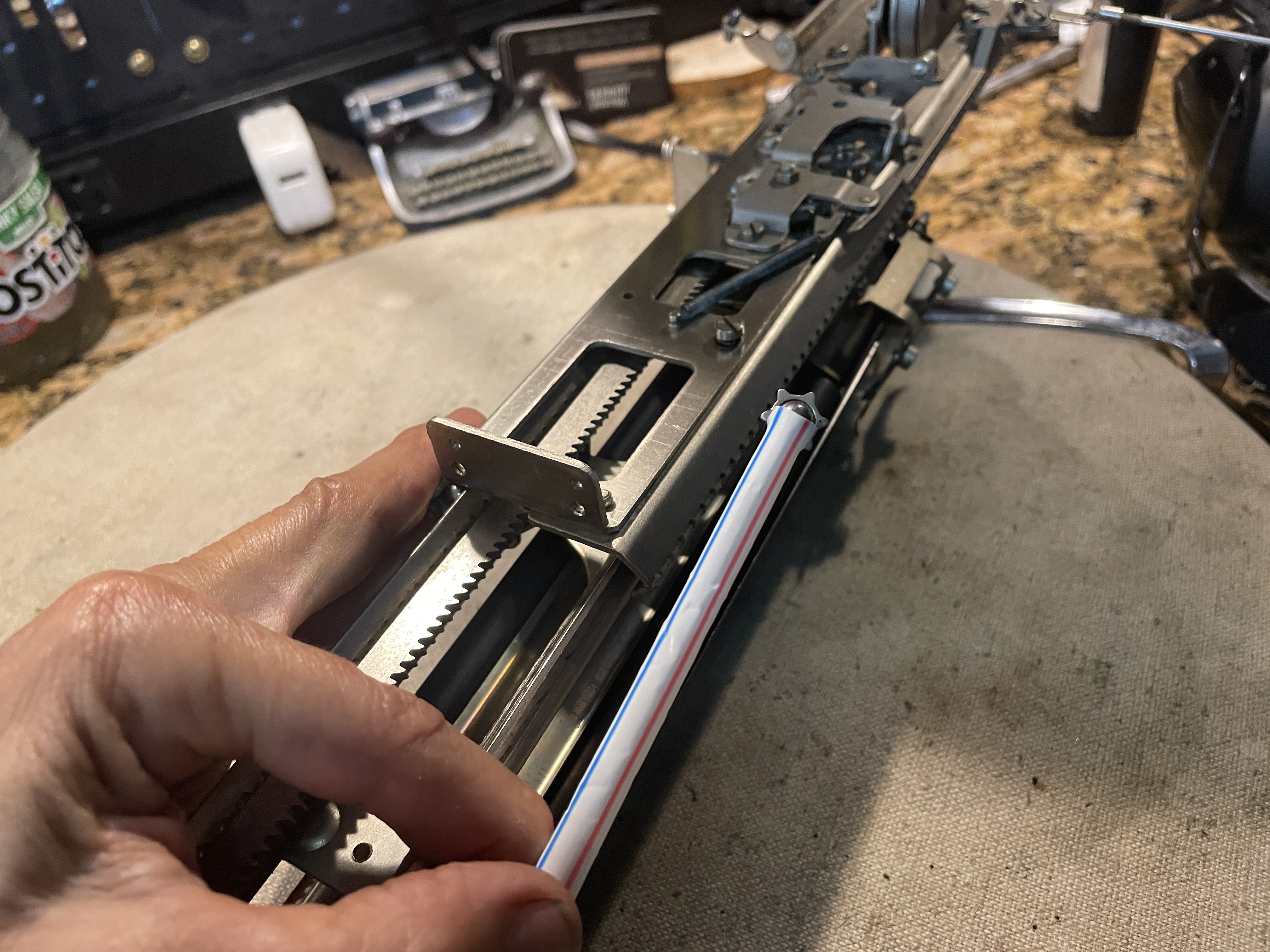 Installing ball bearing and pinions in carriage rails of 1949 Remington All-New Portable