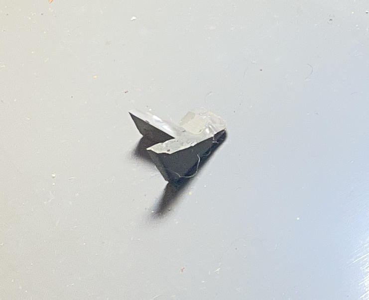 piece of spacebar found in bottom of case of Smith-Corona Corsair Deluxe made in England